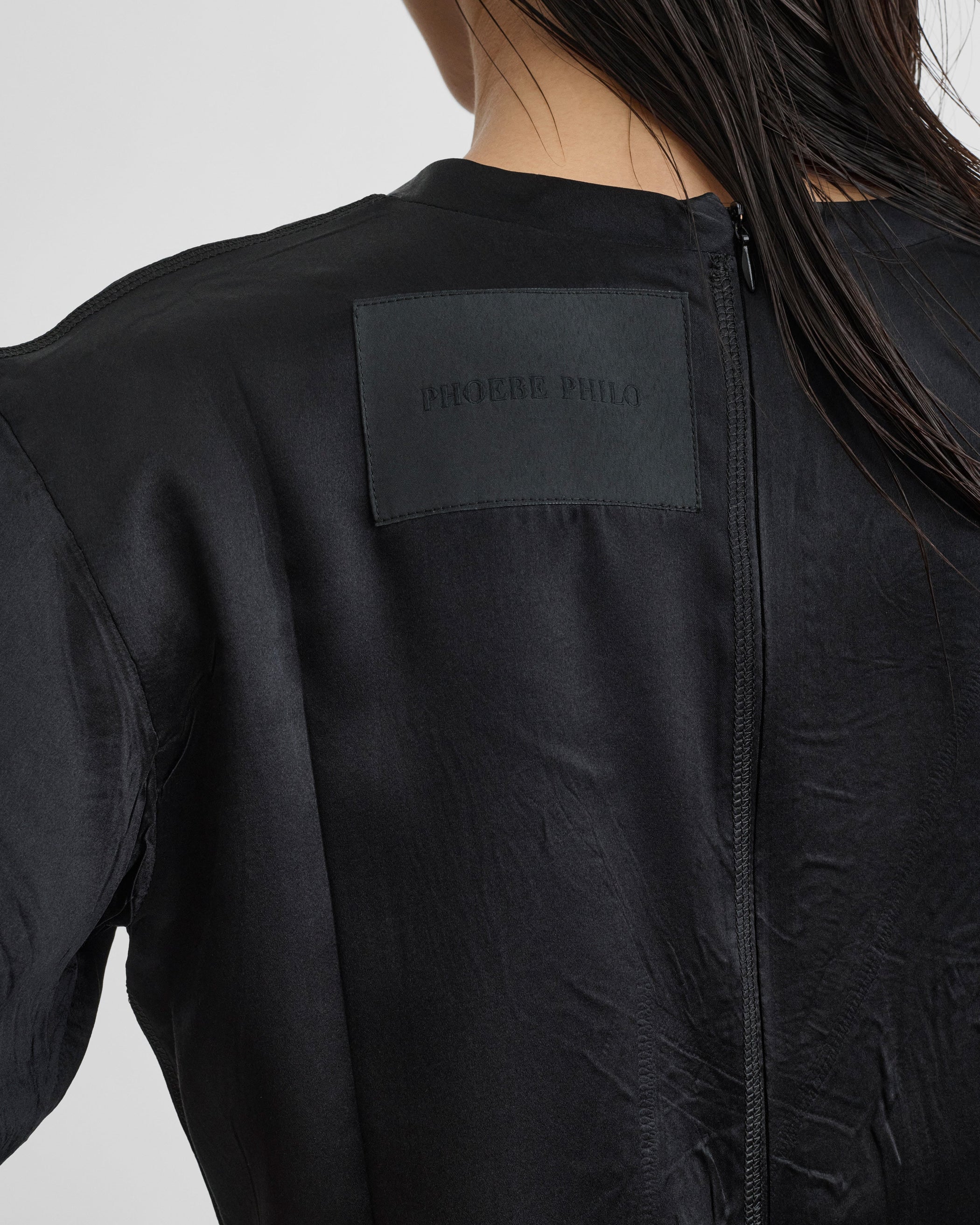 Back detail view of model wearing GRAPHIC T in black silk