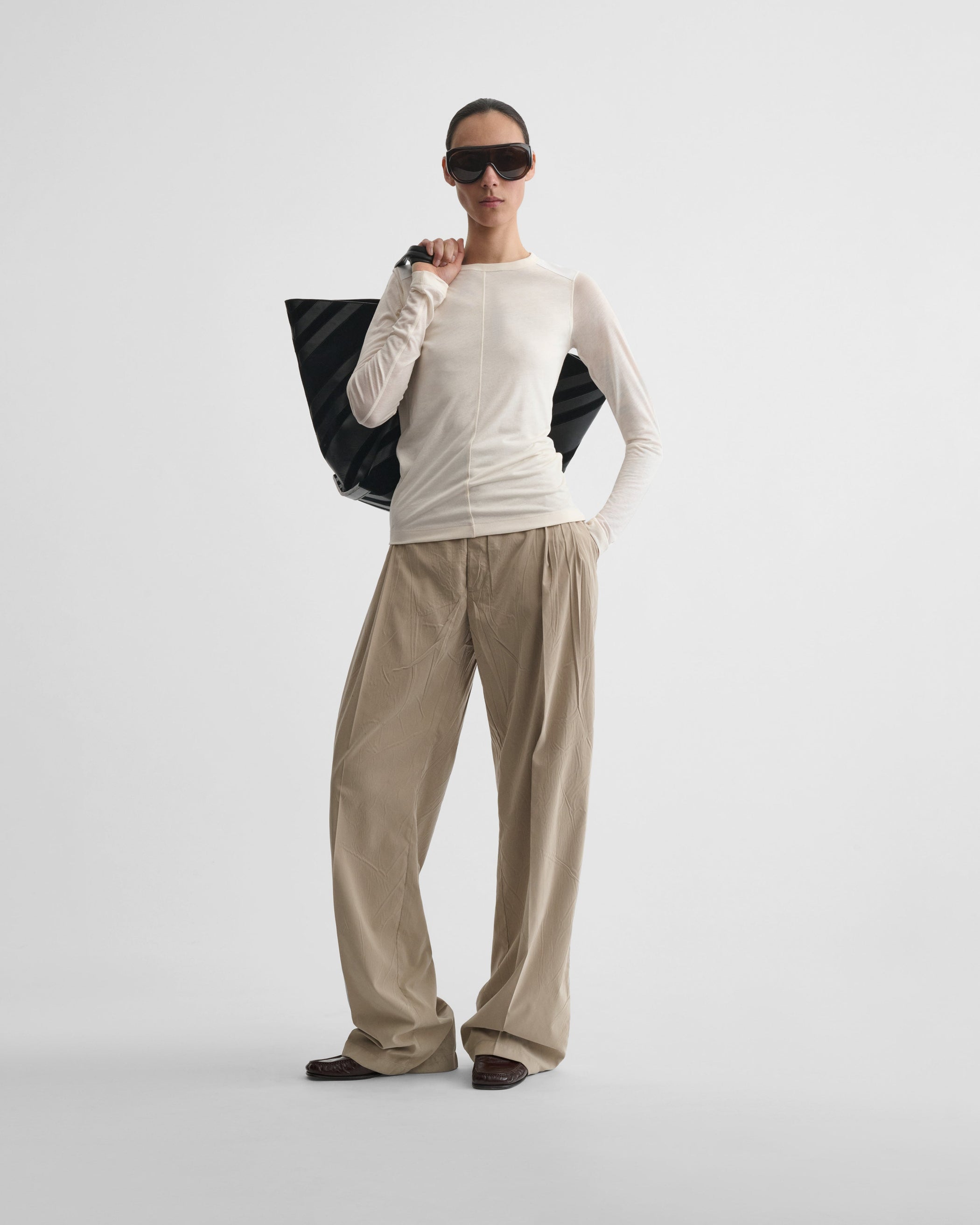 Front view of model wearing CREW NECK TOP in cream cotton