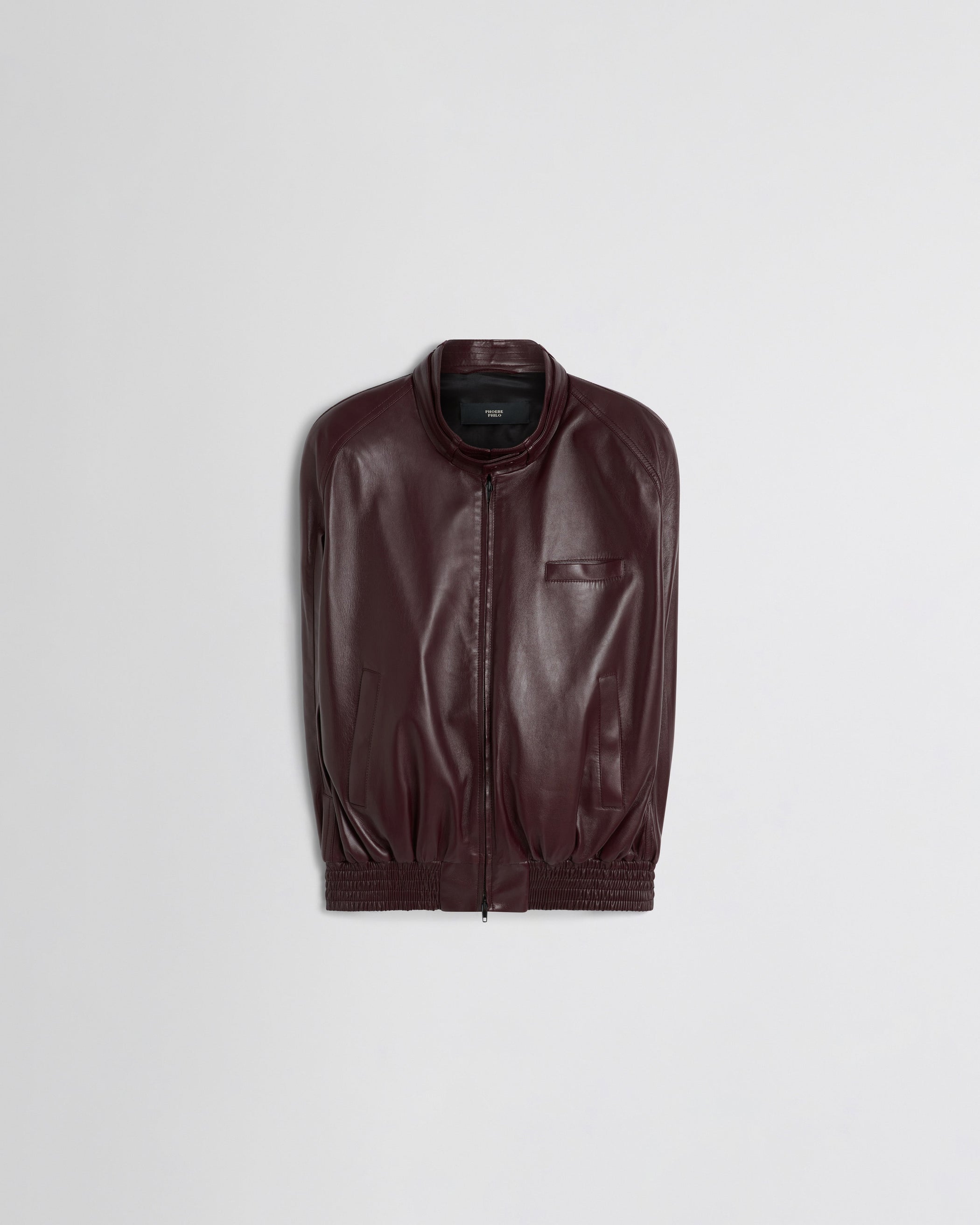 Flat front view of CAPE BOMBER in merlot leather