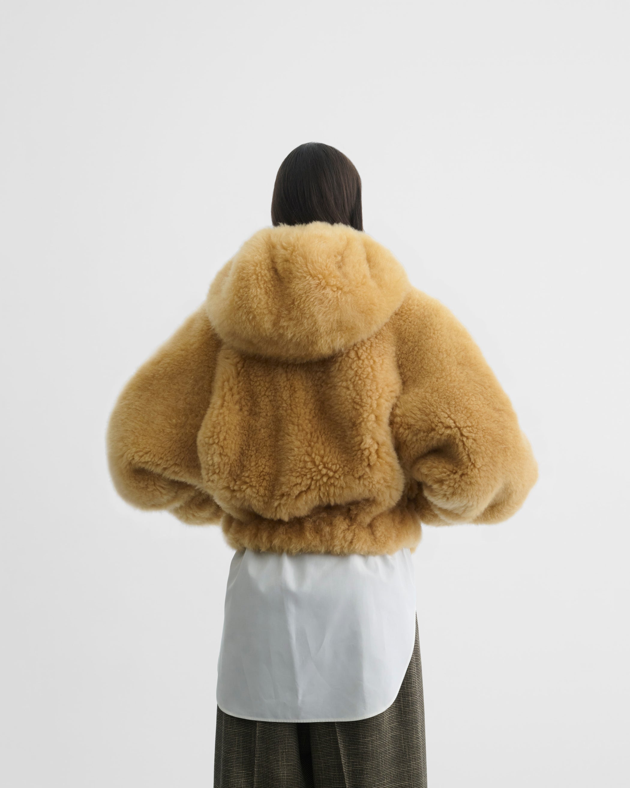 Back view of model wearing SUPER TEDDY HOODIE in honeycomb shearling