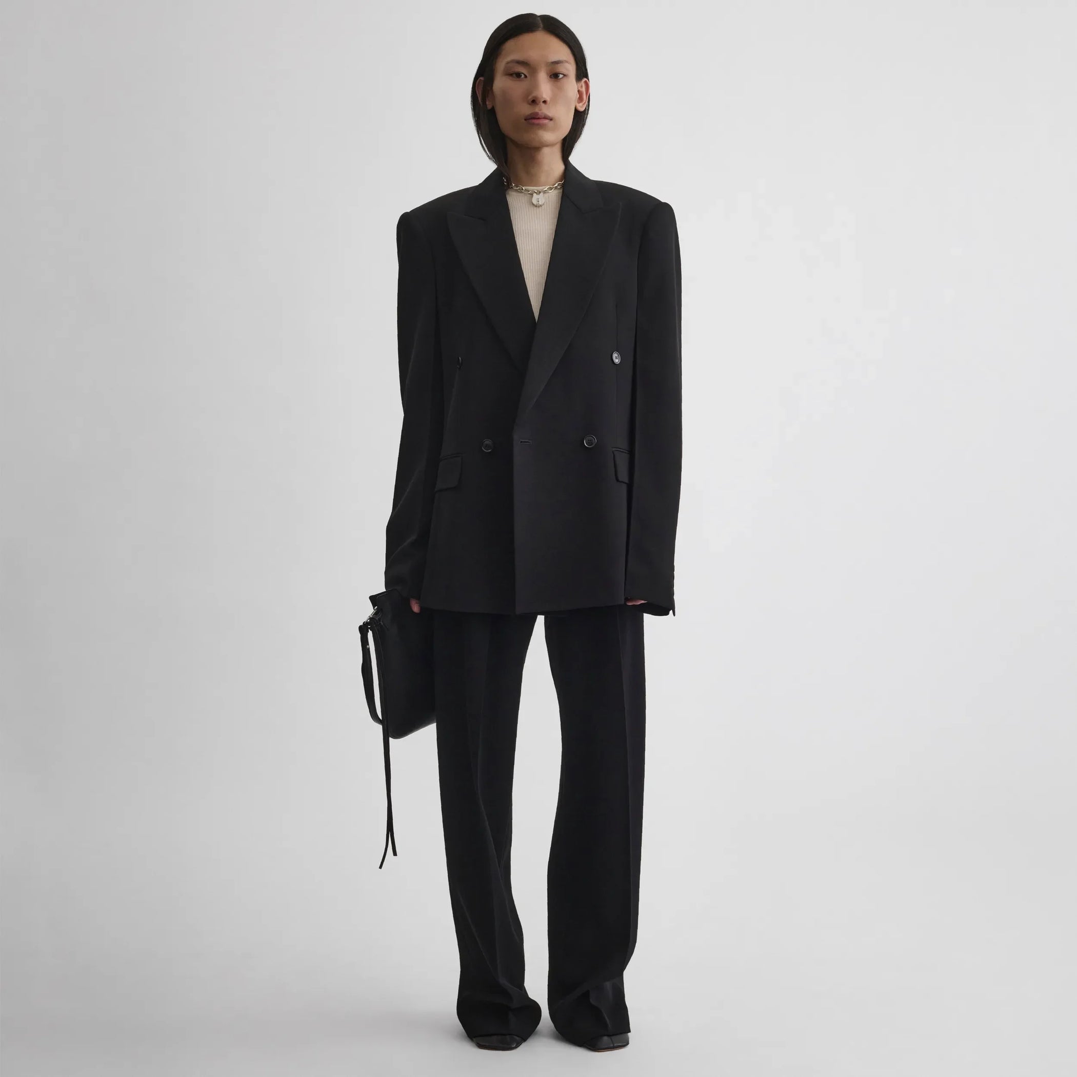 Front view of model wearing Milanese Jacket in black.